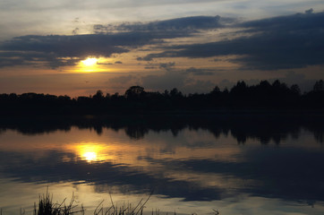 Sunset over forest lake