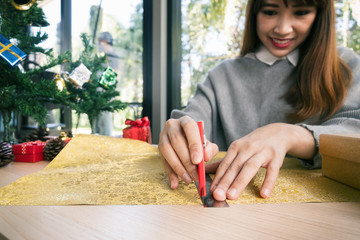 woman wearing santa dress packaging gift box