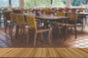 wood table and chair in cafe cafeteria. restaurant interior