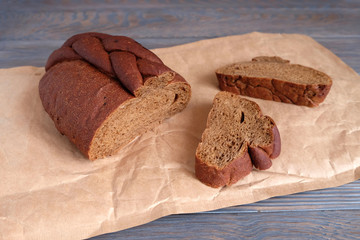 Black bread on a wooden texture