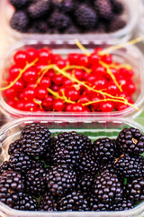 Berry fruits at marketplace  - organic  blueberries, raspberries, strawberries, cherries. Healthy local food market concept..