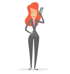 Vector cartoon image of a business woman with long red hair in a gray pantsuit talking and smiling on a black smartphone on a white background. Business illustration. Vector illustration.