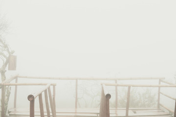 Fototapeta na wymiar wood balcony in mist. bamboo terrace in fog.