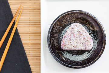 Onigiri , Japanese food rice ball made from white rice formed into triangular or cylindrical shapes. And often wrapped in nori (seaweed).