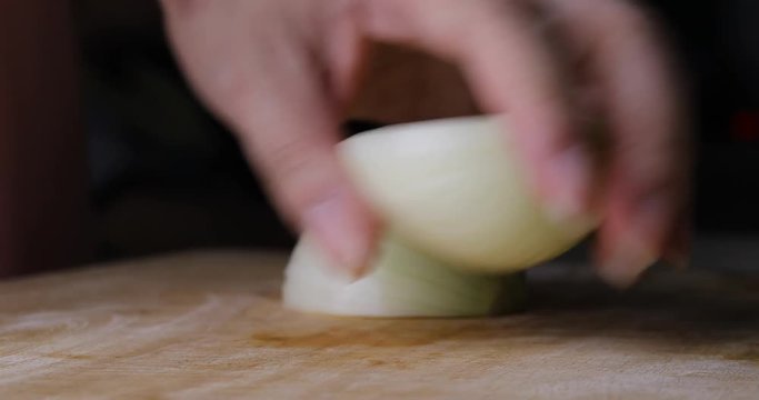 chef cooking food sliced onion with knife on wooden chopping board