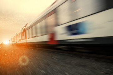 Fototapeta na wymiar Fast moving train at dawn