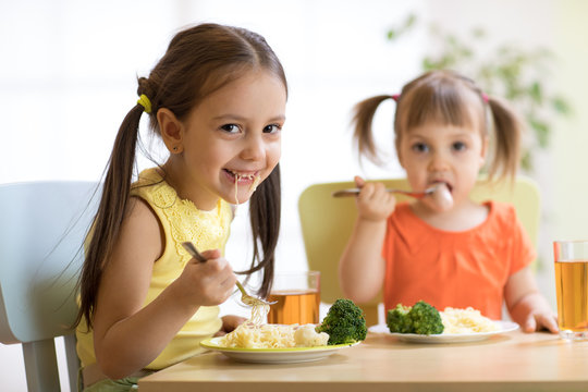 kids eating healthy food in nursery or at home