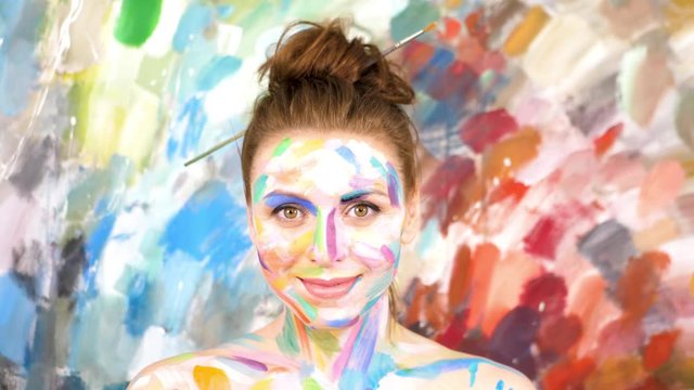 Artist Paints applying make up. Woman-Picture. Slow motion.