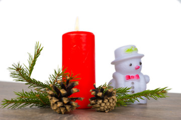 christmas composition with red candle and snowman