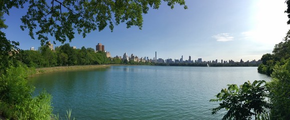 Lake at Central Park and buildings of New York in panorama