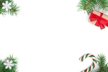 Christmas Frame of Fir tree branch with candy canes and snow isolated on white background with copy space for your text