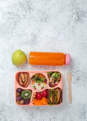  Open lunch box with healthy lunch on the grey background with copy space © lithiumphoto