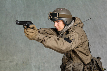 Fototapeta premium Soldier man holding his gun