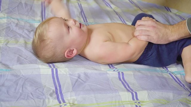 Father with his son doing special gymnastic exercises. Healthy lifestyle. Slow motion