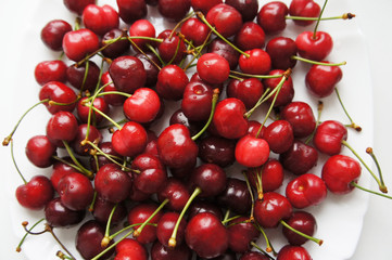 Obraz na płótnie Canvas Sweet cherry or cherries red fruits in white plate