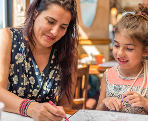 Mother and daughter do homework while on vacation to keep up