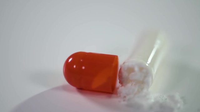Pharmaceuticals and drugs, view of the opened capsule with medicine. 
