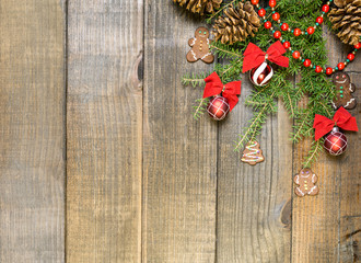 Christmas decorations and fir branches on wooden board background with copy space.
