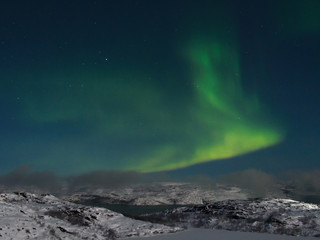 Fototapeta na wymiar Northern lights, aurora over hills and tundra in the winter.