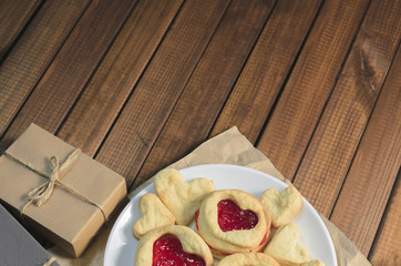 Cookies in the shape of hearts and gifts Valentine's day, top view, free space for text