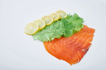 fillet of smoked red fish with lemon and herbs, isolated white background