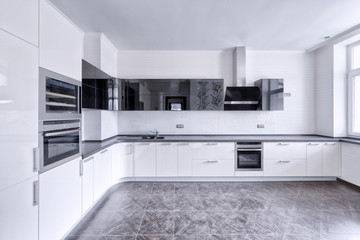 Modern design white kitchen in a spacious apartment.