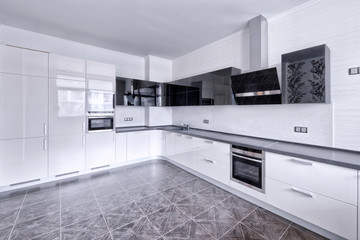 Modern design white kitchen in a spacious apartment.