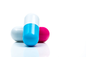 Two capsule pills isolated on white background. Global healthcare concept.