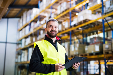 Male warehouse worker with clipboard.