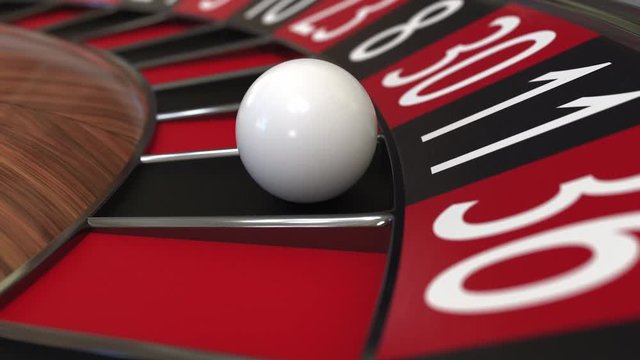 Casino roulette wheel ball hits 11 eleven black