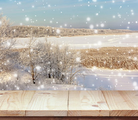 Empty wooden table on background winter landscape.