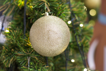 Big twinkle ball decorated on Christmas tree background beautifully. 