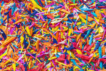 Colorful pencil's shavings for background. Closeup, top view