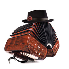 Bandoneon, tango instrument with a male hat on top on white