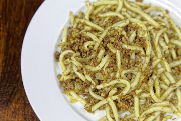 Spaghetti with meat on a white plate. Fresh pasta for lunch