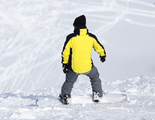 Fototapeta na wymiar Man is snowboarding in the snow in winter