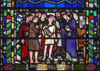 LONDON, GREAT BRITAIN - SEPTEMBER 16, 2017: The scene of the Anointing of David by Samuel on the stained glass in church St Etheldreda by Charles Blakeman (1953 - 1953).