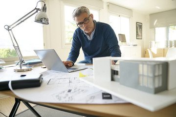 Architect in office working on construction project