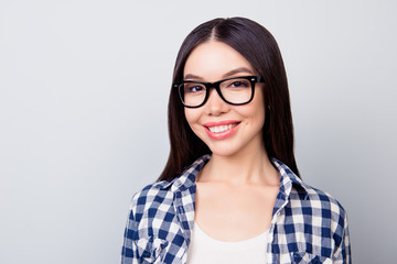 Close up of young smiling  woman in casual  clothing, standing over grey background. Education concept