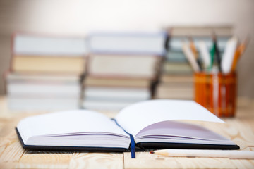 Fototapeta premium Textbooks and books on a wooden table