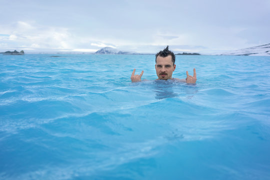 Guy Relaxing In Geothermal Pool Outdoors