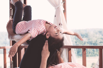 Fototapeta premium Happy asian child girl laughing and having fun to play with her mother in the room in vintage color tone