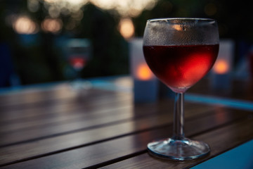 Wineglass on wood table in eveninglight