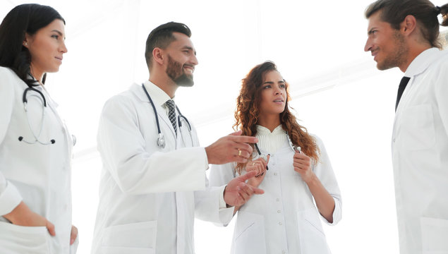 Group Of Doctors Discussing In Hospital.