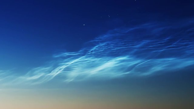 noctilucent clouds NLC with stars and filament gravity wave structure in summer morning twilight timelapse