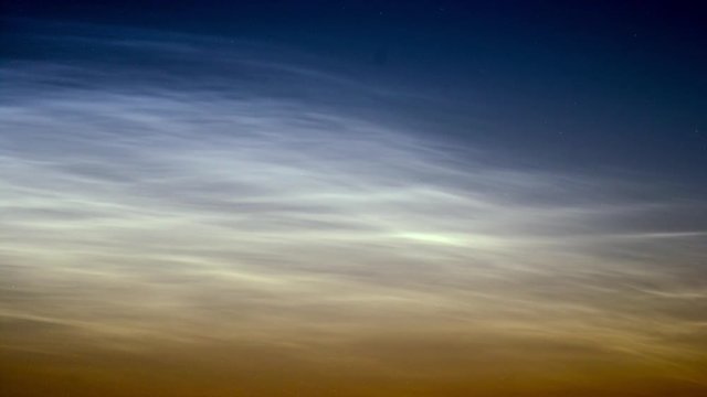 noctilucent clouds NLC with filament gravity wave structure in midnight sun timelapse TELE SHOT