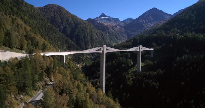 Mountain bridge, Cinema 4k aerial view over a big bridge, between alpines, on a sunny fall day, on simplon pass, in wallis, of the alps in Switzerland