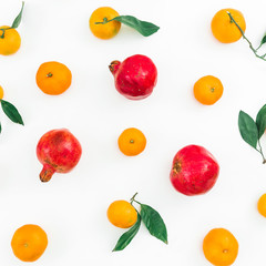 Citrus with leaves and garnet fruits isolated on white background. Flat lay. Top view