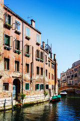 Fototapeta na wymiar VENICE, ITALY - May 18, 2017 : View of water street and old buildings in Venice on May 18, 2017. its entirety is listed as a World Heritage Site, along with its lagoon