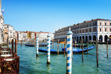 Fototapeta premium VENICE,ITALY- May 18, 2017 : Tourists on water street with Gondola in Venice. its entirety is listed as a World Heritage Site, along with its lagoon